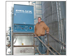 Grain Department Manager Kasey Nash is shown with the new dryer’s Moisture- Link control panel.