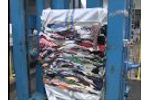 Pit press for baling used clothing - Video