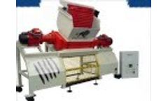 Evashred EV110E shredding tyres with a force feed hopper