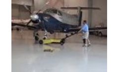 An aircraft tow pulls large aircraft in an airplane hangar Video
